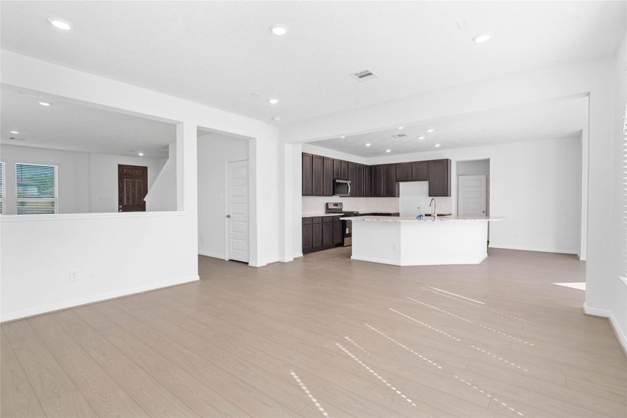 Stunning open-concept design seamlessly connecting the family, breakfast nook, and kitchen areas—perfect for both everyday living and entertaining!