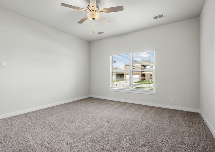 The spacious master bedroom has a window that lets in great, natural light and backyard views.