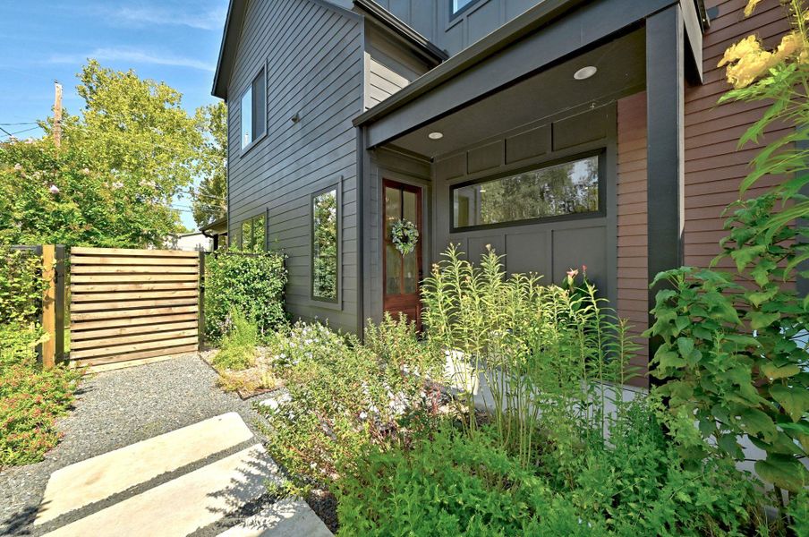Front yard with native landscaping and secondary gate to additionally enclose the backyard. Front yard with native landscaping and secondary gate to additionally enclose the backyard.