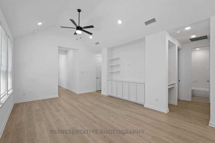 Unfurnished living room featuring light wood-type flooring, a ceiling fan, vaulted ceiling, and recessed lighting