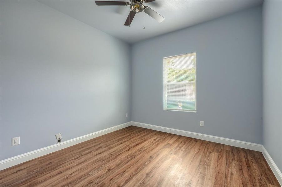 Spare room featuring ceiling fan and wood-type flooring