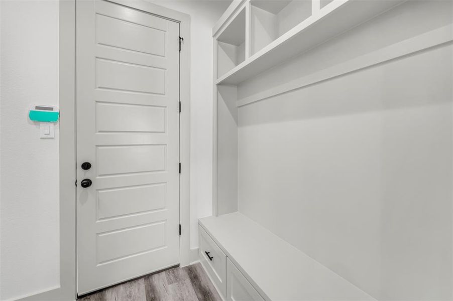 Mudroom with light wood-style flooring