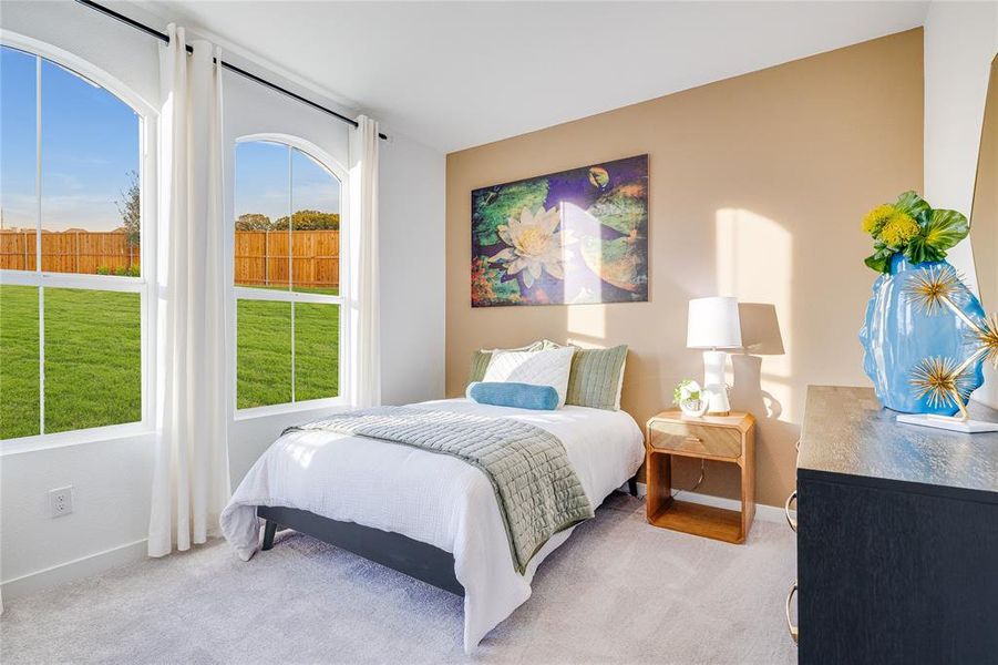 Bedroom featuring light carpet and baseboards