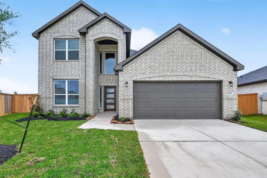 Front exterior of a new home in Grand Magnolia, Magnolia, TX, highlighting curb appeal (Image 1). Front exterior of a new home in Grand Magnolia, Magnolia, TX, highlighting curb appeal (Image 1).