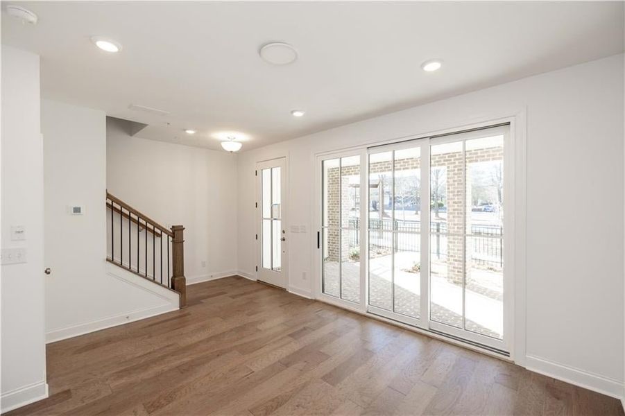 The front door enters through the terrace level media/flex room. This room serves as a flexible space for whatever suits your needs.