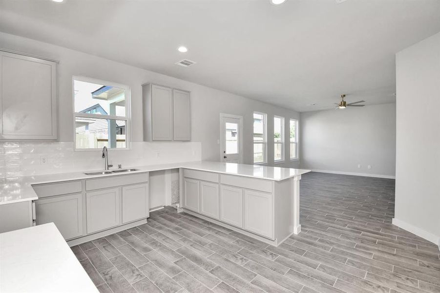 This generously spacious kitchen is a dream realized! Sample photo of completed home with similar floor plan. As-built interior colors and selections may vary.