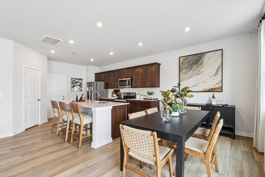 A kitchen with a dining table. A kitchen with a dining table.