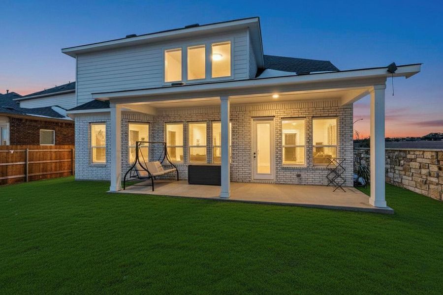 Back of house with brick siding and a patio area