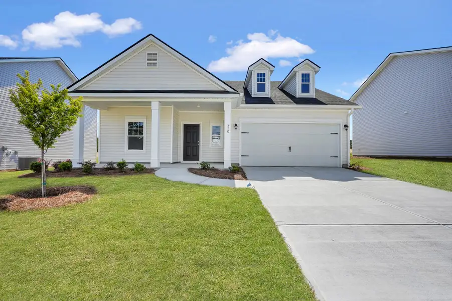 Front exterior of a home in the Woodland Cove community, located in Brunswick, GA (Image 9).
