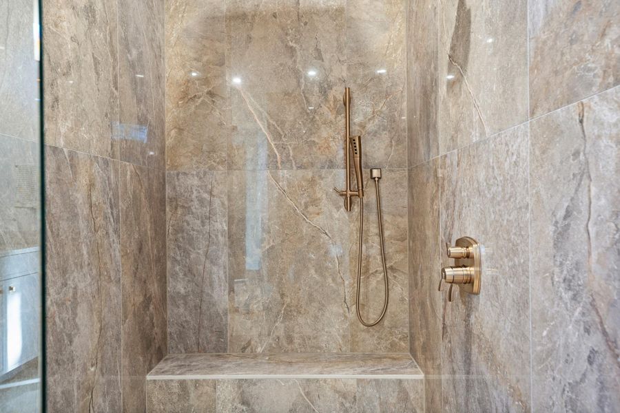 Bathroom with a marble finish shower