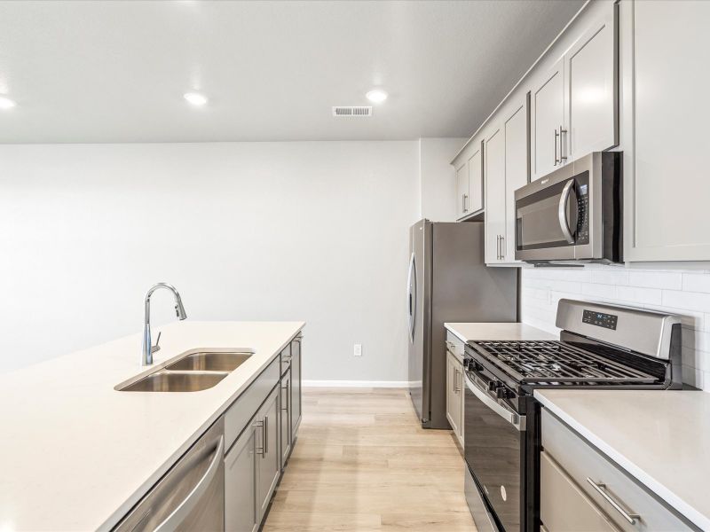 Kitchen in the Orchard floorplan at a Meritage Homes community in Aurora, CO.