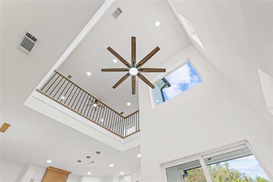Detailed view of recessed lighting, a skylight, and a ceiling fan