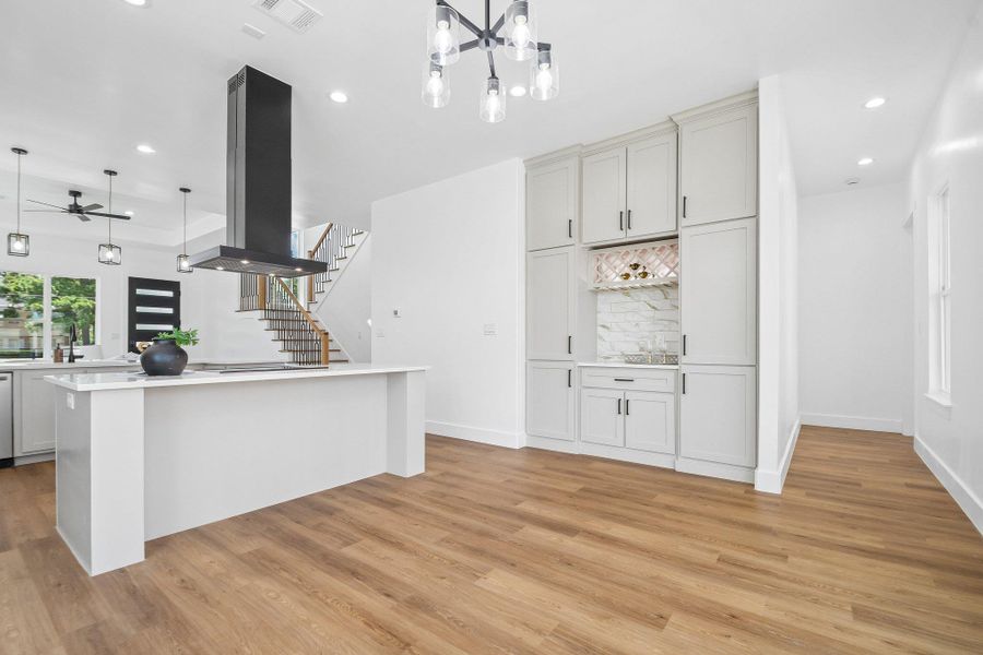 Warm wood flooring contrasts beautifully with crisp white walls and custom cabinetry. Warm wood flooring contrasts beautifully with crisp white walls and custom cabinetry.