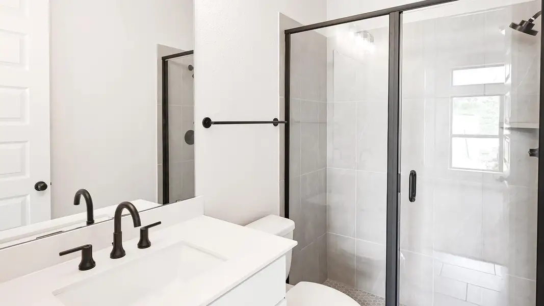 Bathroom featuring vanity and a shower stall Bathroom featuring vanity and a shower stall