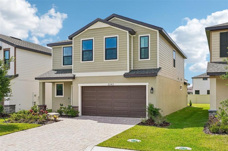 Front exterior of a new home in Grasslands West, Lakeland, FL, highlighting curb appeal (Image 23).