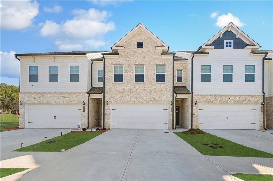 Front exterior of a new home in Auburn Ridge, Riverdale, GA, highlighting curb appeal (Image 1). Front exterior of a new home in Auburn Ridge, Riverdale, GA, highlighting curb appeal (Image 1).