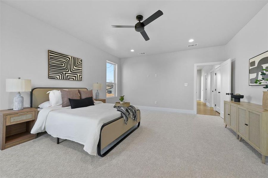 Carpeted bedroom featuring ceiling fan