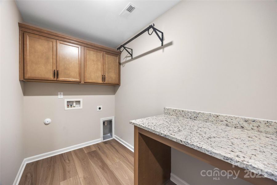 Laundry room with folding table and cabinets. Laundry room with folding table and cabinets.