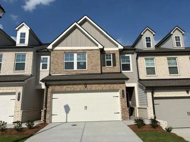 Front exterior of a new home in Towns at Ivy Creek, Buford, GA, highlighting curb appeal (Image 1). Front exterior of a new home in Towns at Ivy Creek, Buford, GA, highlighting curb appeal (Image 1).