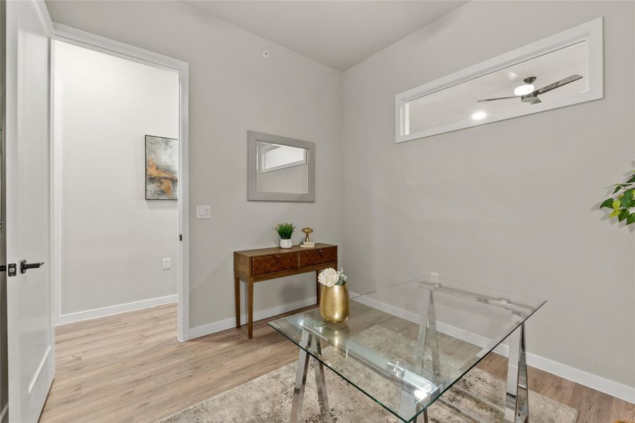 Office with light wood finished floors and baseboards