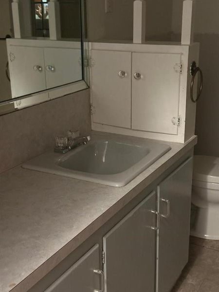 Bathroom featuring vanity and tile patterned flooring