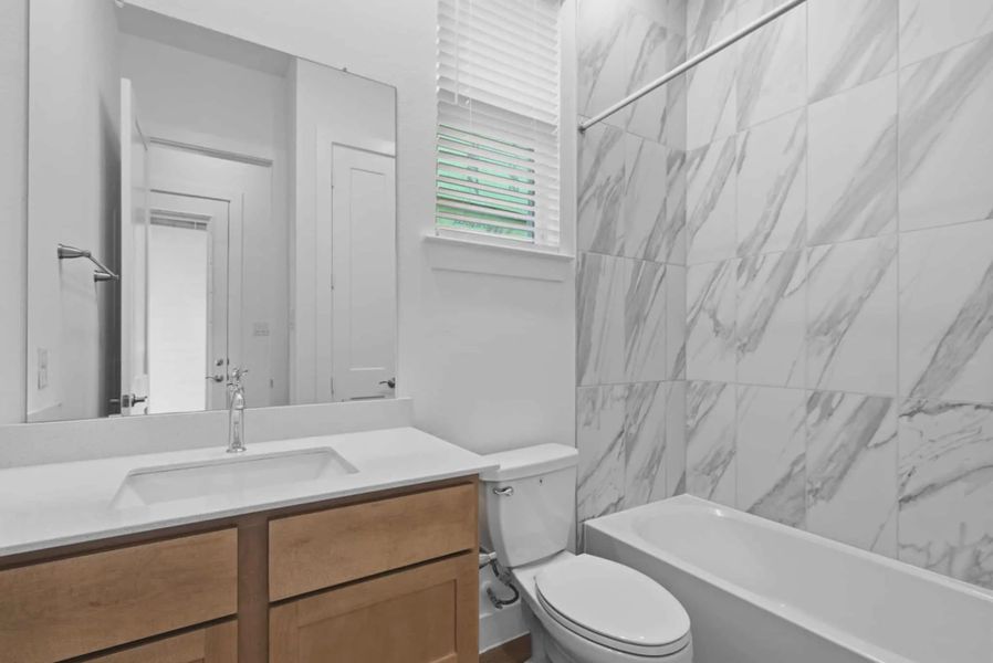 Representative furnished interior of a home built from the Summerton by Chesmar Homes in Beacon Point, Texas City (Image 11).