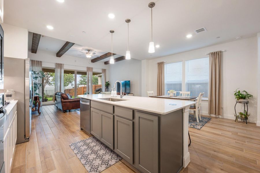 An open-concept living space with a gourmet kitchen, dining area, and inviting living room. An open-concept living space with a gourmet kitchen, dining area, and inviting living room.