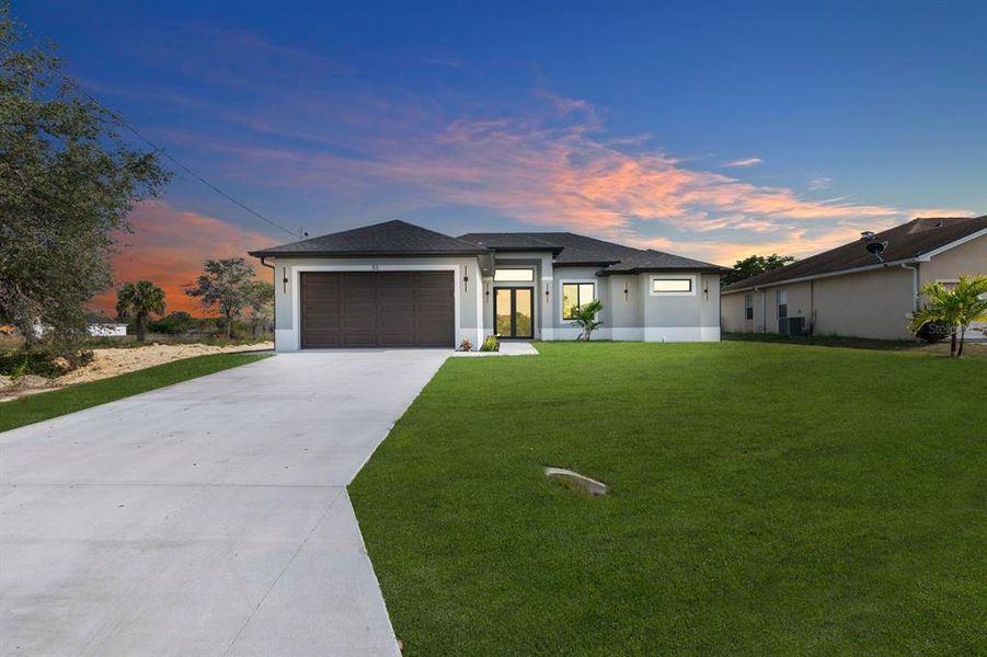 Front exterior of a new home in , Lehigh Acres, FL, highlighting curb appeal (Image 22).