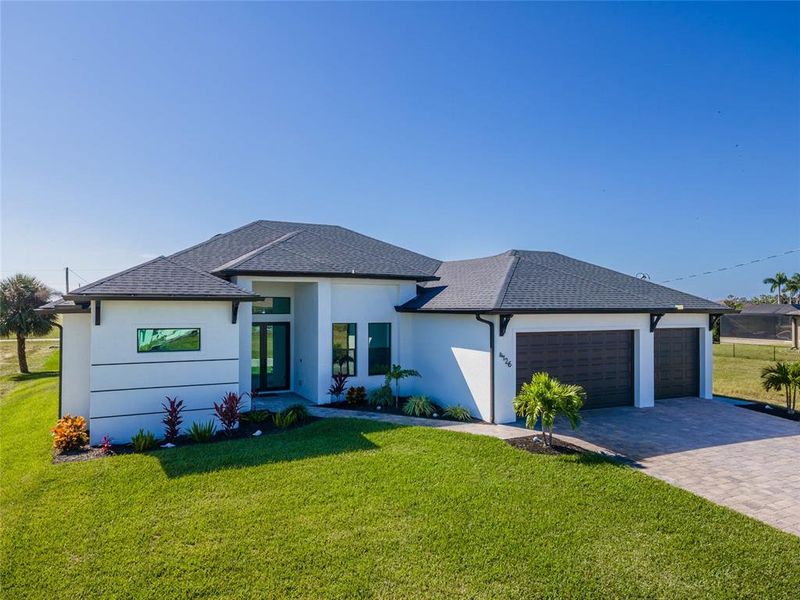 Front exterior of a new home in , Cape Coral, FL, highlighting curb appeal (Image 29). Front exterior of a new home in , Cape Coral, FL, highlighting curb appeal (Image 29).