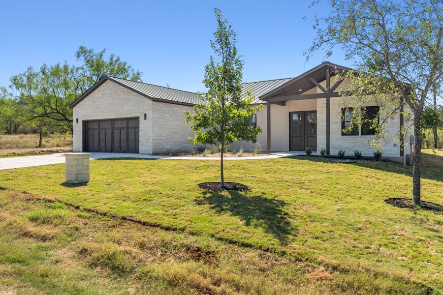 Front exterior of a new home in , Horseshoe Bay, TX, highlighting curb appeal (Image 2). Front exterior of a new home in , Horseshoe Bay, TX, highlighting curb appeal (Image 2).