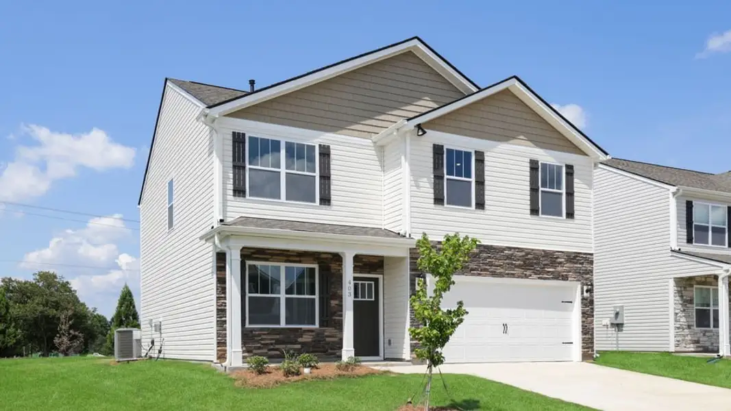 Front exterior of a new home in Durbin Meadows Traditions, Fountain Inn, SC, highlighting curb appeal (Image 2). Front exterior of a new home in Durbin Meadows Traditions, Fountain Inn, SC, highlighting curb appeal (Image 2).