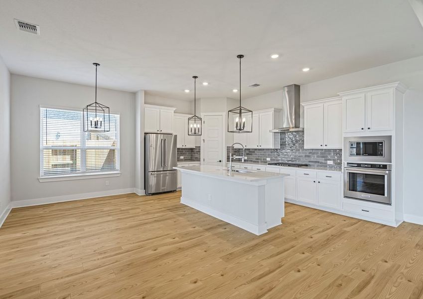The kitchen and dining room sit adjacent to one another. The kitchen and dining room sit adjacent to one another.