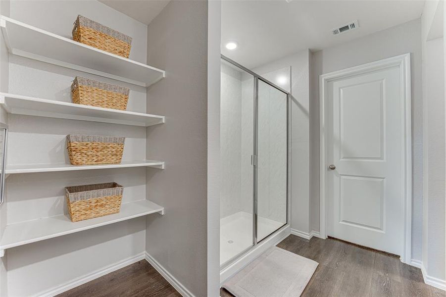 Bathroom with hardwood / wood-style flooring and walk in shower