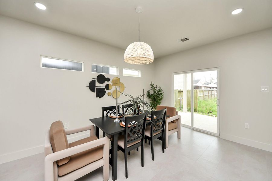 Enjoy morning coffee in this bright dining space with direct access to the back patio.