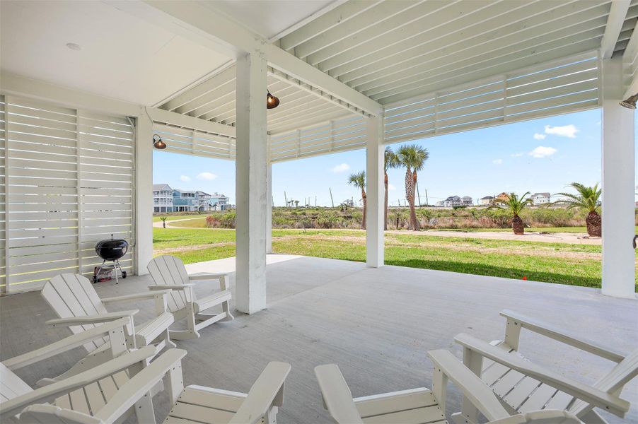 The large under-home patio provides a versatile area for grilling, games, or hosting gatherings, while still offering convenient covered parking.