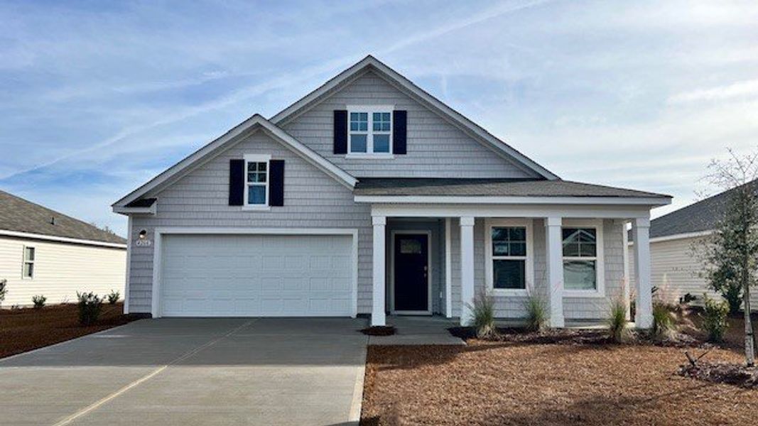 Front exterior of a new home in The Meadows at Wildwood Village, Shallotte, NC, highlighting curb appeal (Image 1).