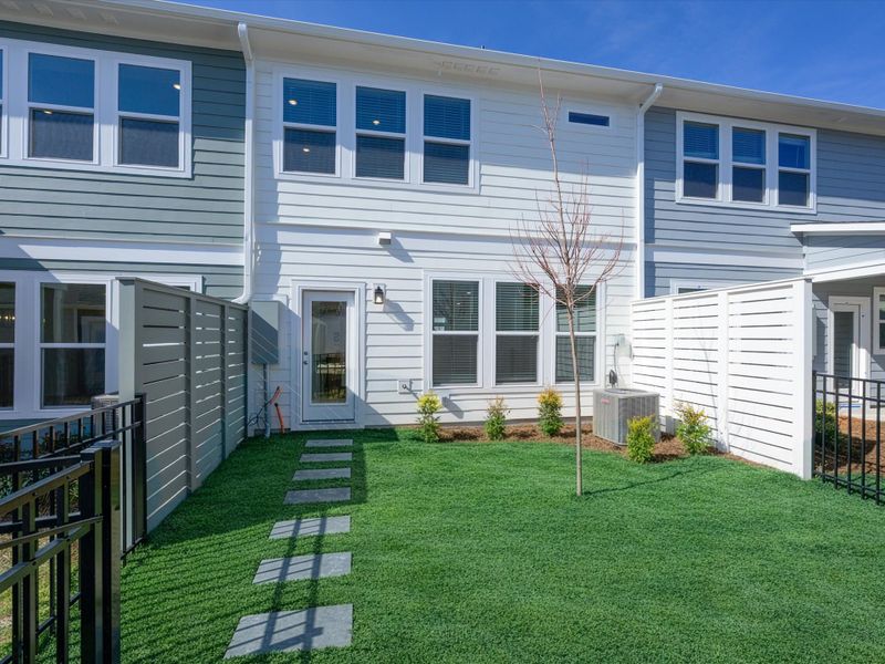 Exterior details and patio area of a home in North Creek Village - Townhomes, Huntersville (Image 3).