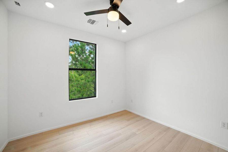 Empty room with light wood-type flooring, recessed lighting, and a ceiling fan Empty room with light wood-type flooring, recessed lighting, and a ceiling fan
