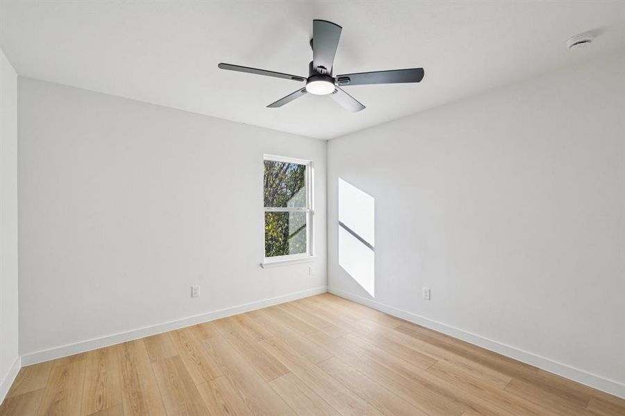 Spare room with light wood-style floors and ceiling fan