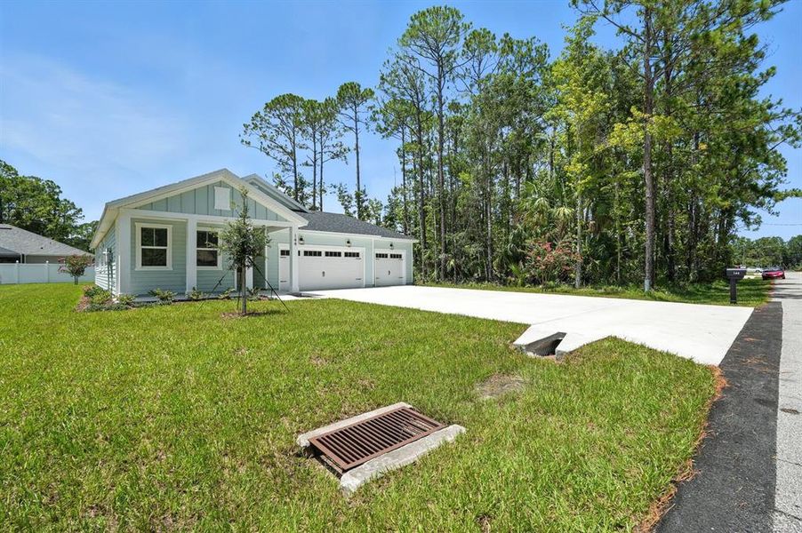 Front exterior of a new home in Palm Coast Homes, Palm Coast, FL, highlighting curb appeal (Image 21).