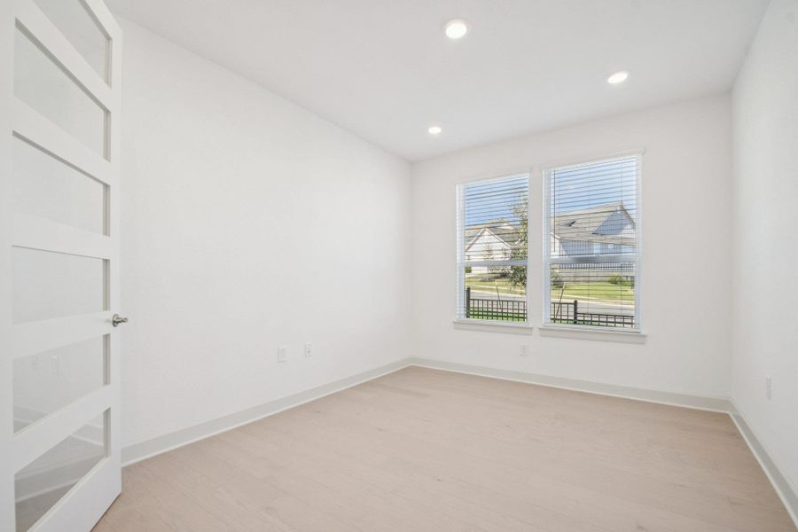 Unfurnished room with light wood finished floors and recessed lighting Unfurnished room with light wood finished floors and recessed lighting