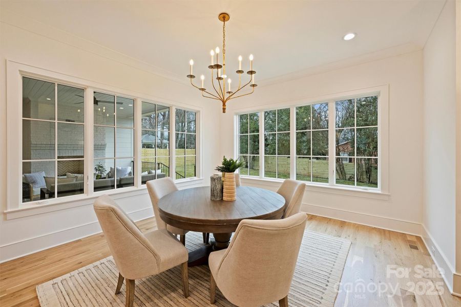 The elegant dining room also sits conveniently off of the kitchen, surrounded by these beautiful windows, which cultivate a bright and airy atmosphere.