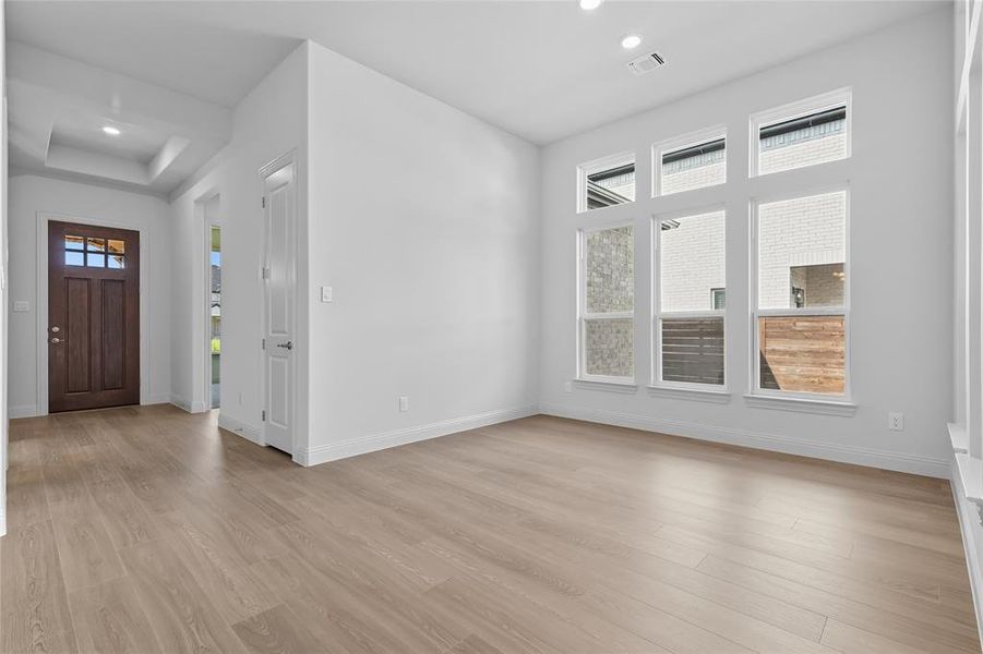 Entryway with light wood-style flooring and recessed lighting