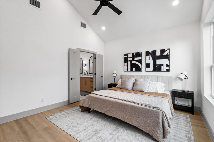 Framed by vaulted ceilings and wide-plank flooring, the primary suite flows seamlessly into a spa-inspired bath through double doors—offering both comfort and convenience in a refined, retreat-like setting. A perfect blend of privacy and polish. Framed by vaulted ceilings and wide-plank flooring, the primary suite flows seamlessly into a spa-inspired bath through double doors—offering both comfort and convenience in a refined, retreat-like setting. A perfect blend of privacy and polish.