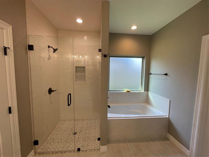 Full bathroom with a whirlpool tub, a shower stall, and recessed lighting
