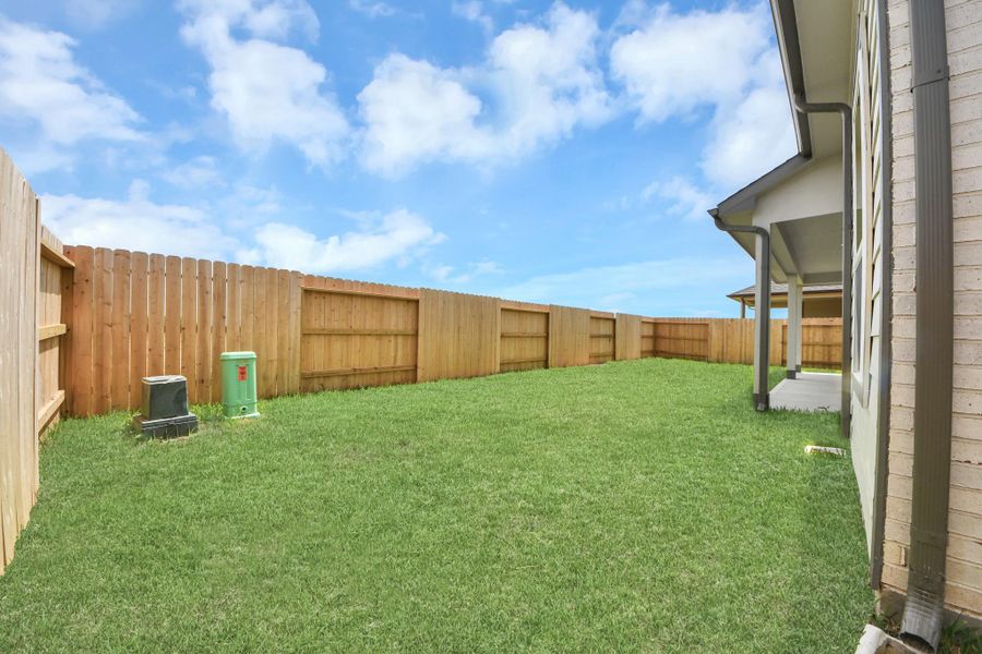 Discover the charm of this spacious backyard featuring a delightful covered patio. With ample room for both play and relaxation, it's the perfect outdoor haven. Tailor this space to your liking with patio furniture, a BBQ pit, and more. The potential for creating your dream outdoor living area is limitless! Discover the charm of this spacious backyard featuring a delightful covered patio. With ample room for both play and relaxation, it's the perfect outdoor haven. Tailor this space to your liking with patio furniture, a BBQ pit, and more. The potential for creating your dream outdoor living area is limitless!