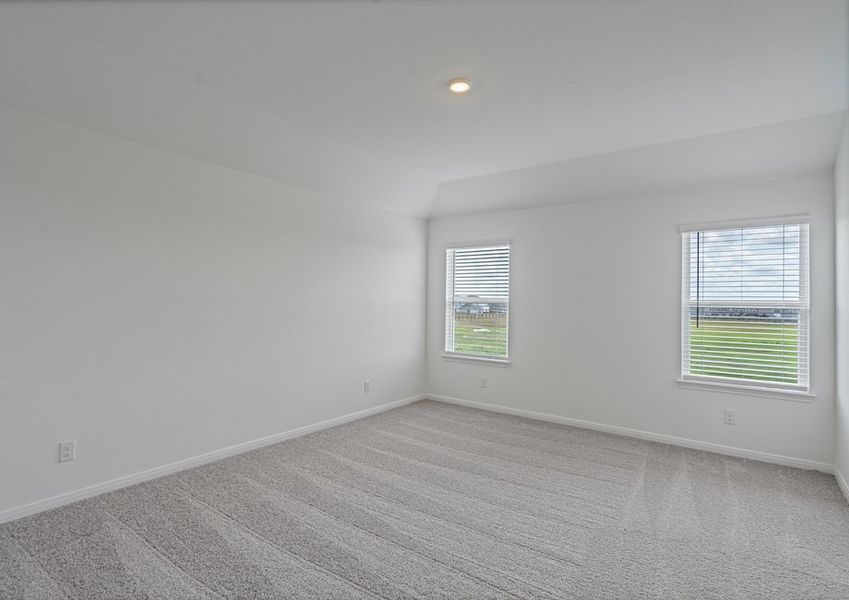 Master bedroom with teo window overlooking the private backyard
