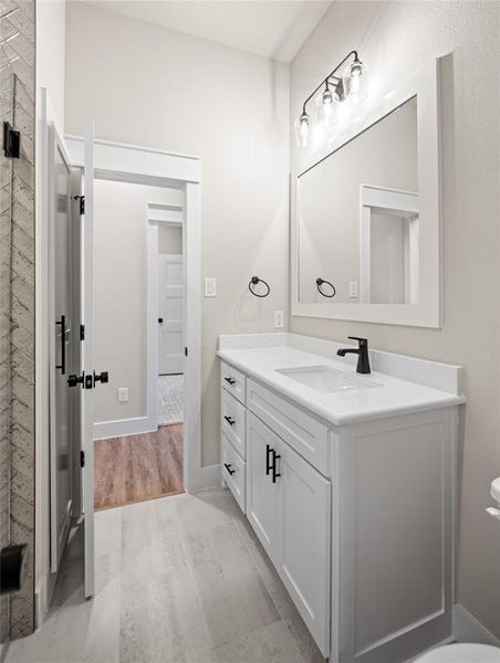 Bathroom featuring vanity and light wood-type flooring
