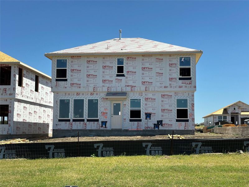 A new construction with a classic gabled roofline awaits its finishing touches. A new construction with a classic gabled roofline awaits its finishing touches.