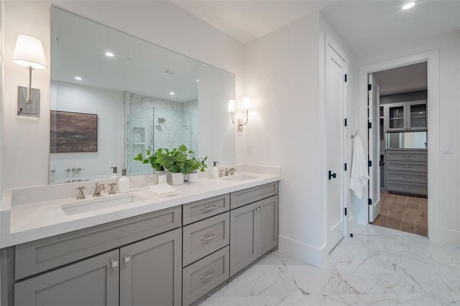 Bathroom with vanity and a shower with door